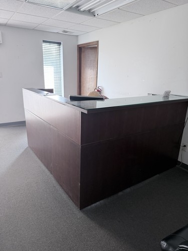 Dark wood reception desk front - dark,