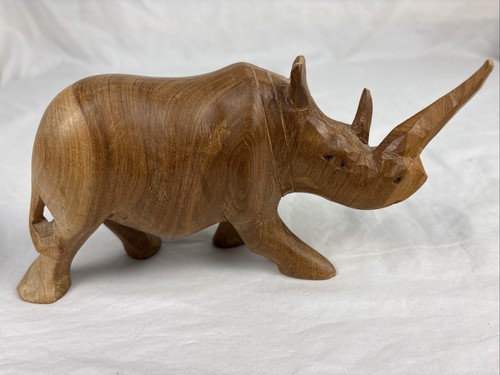 Hand carved wood rhinoceros - hand,