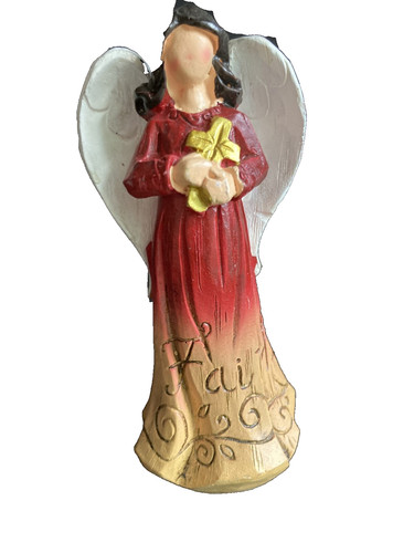 Angel figurine holding cross