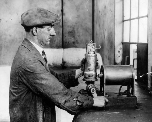 Workman testing miners lamps - workman,