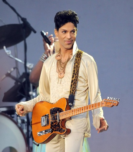 Prince playing guitarr in - a,